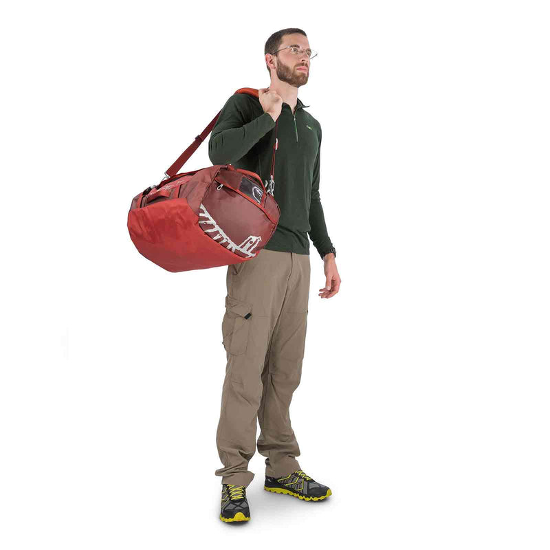 Load image into Gallery viewer, osprey transporter 65 duffel bag on body 3 ruffian red
